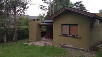 a small house with a window in the yard at Cabañas Kangarú in Santa Rosa de Calamuchita