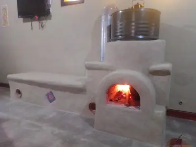 a stove with a fire in a room at Cabañas Kangarú in Santa Rosa de Calamuchita