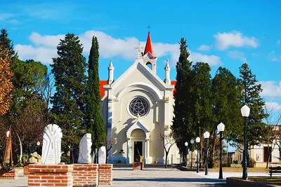 a large white church with a red roof at BoraBora in Nono