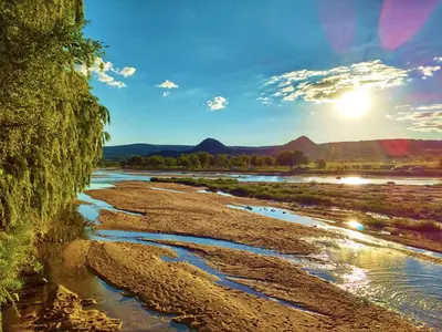 a view of a river with the sun in the sky at BoraBora in Nono