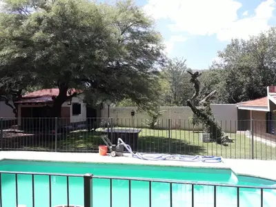 a swimming pool in a yard with a fence at La Casa de Ana in Bialet Massé