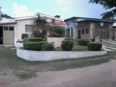 a house with a yard with bushes and trees at La Casa de Ana in Bialet Massé