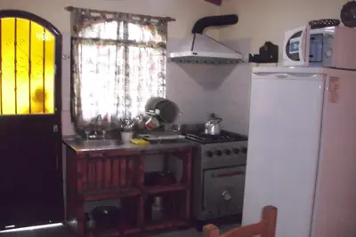 a kitchen with a stove and a refrigerator at La Casa de Ana in Bialet Massé