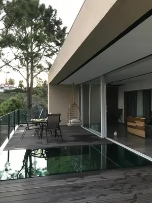 a patio with a table and chairs next to a house at Gran casa del lago in Villa Ciudad de America