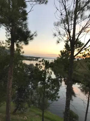 a view of a lake through the trees at Gran casa del lago in Villa Ciudad de America