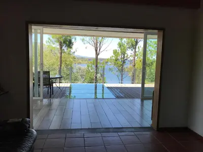 a sliding glass door leading to a patio with a pool at Gran casa del lago in Villa Ciudad de America