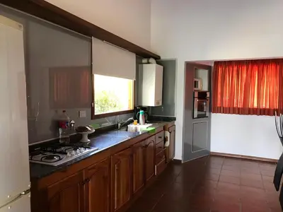 a kitchen with a sink and a stove top oven at Gran casa del lago in Villa Ciudad de America