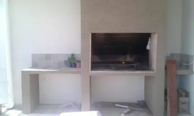 a fireplace is being built in a living room at Un Buen Lugar in Villa Parque Siquiman