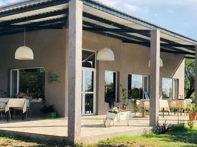 a patio of a house with tables and chairs at CampoAlto Suites in San Javier
