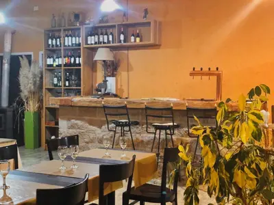 a restaurant with tables and chairs and a bar at CampoAlto Suites in San Javier