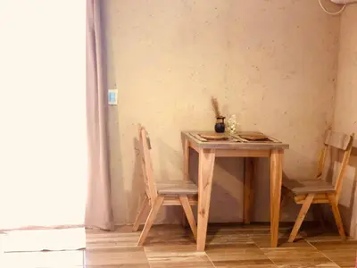 a wooden table with two chairs next to a table with at CampoAlto Suites in San Javier