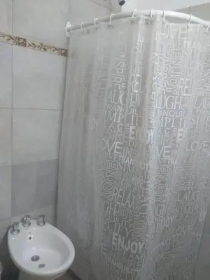 a bathroom with a sink and a shower curtain at El Tatu in La Bolsa