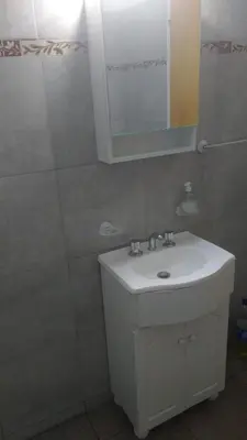 a bathroom with a white sink and a mirror at El Tatu in La Bolsa
