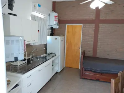 a kitchen with a sink and a refrigerator at El Tatu in La Bolsa