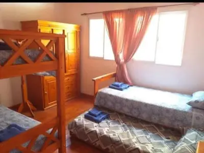 a bedroom with two bunk beds and a window at Casa en Balcón de Mallín, Mirador del Lago in Bialet Massé