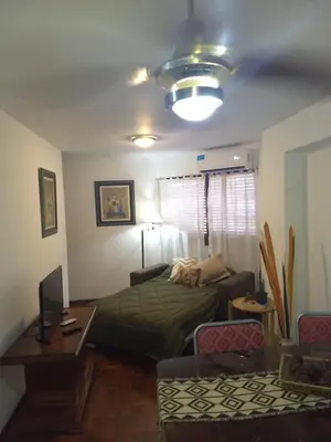 a bedroom with a bed and a couch and a table at Excepcional dpto frente a Plaza de la Intendencia in Cordoba