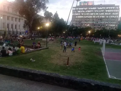 a crowd of people sitting in a park at night at Excepcional dpto frente a Plaza de la Intendencia in Cordoba