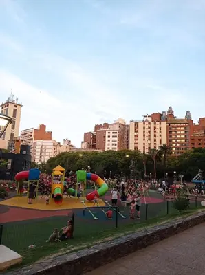 a park with a playground with people playing in it at Excepcional dpto frente a Plaza de la Intendencia in Cordoba