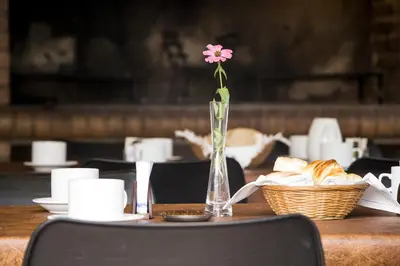 a vase with a flower in it sitting on a table at Casa Decla in Villa Carlos Paz