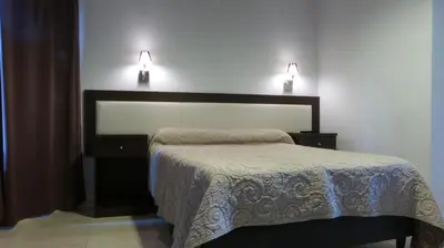 a bedroom with a bed and two lights on the wall at Casa Decla in Villa Carlos Paz