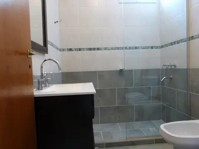 a bathroom with a sink and a shower at Casa Decla in Villa Carlos Paz