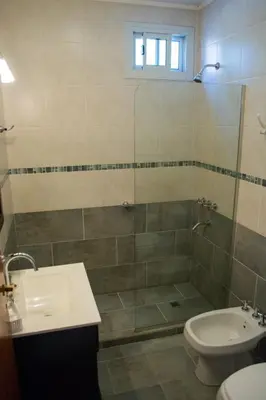 a bathroom with a shower and a toilet and a sink at Casa Decla in Villa Carlos Paz