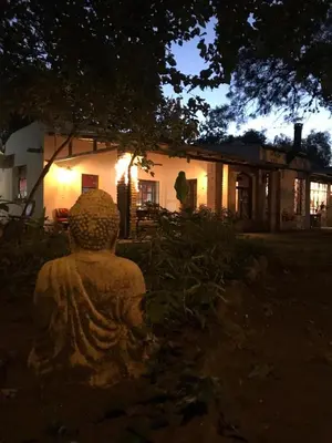 a stone statue in front of a house at night at Posada El Cortijo in San Javier