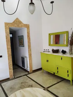 a room with a yellow dresser and a mirror at Soles Blancos Serranita in Alta Gracia