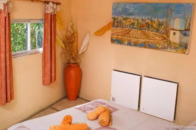 a bedroom with a table with two towels on it at Soles Blancos Serranita in Alta Gracia