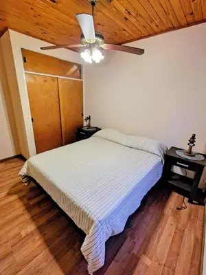 a bedroom with a bed and a ceiling fan at Apart Hotel RITZ in Villa Carlos Paz
