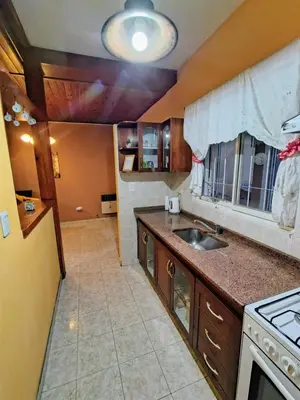 a kitchen with a sink and a stove at Apart Hotel RITZ in Villa Carlos Paz