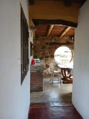 a room with a table and a stone wall at Indra-La Casa de Nanda in San Javier