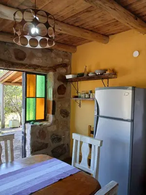 a kitchen with a refrigerator and a table and a window at Indra-La Casa de Nanda in San Javier