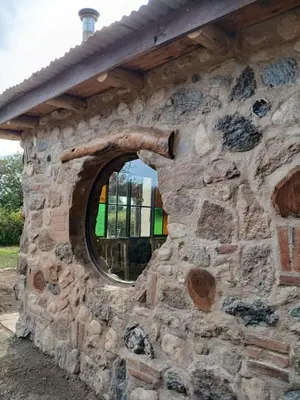 a stone building with a circular window in it at Indra-La Casa de Nanda in San Javier