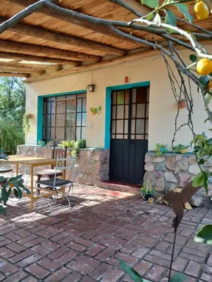 a patio with a table and chairs and a house at Indra-La Casa de Nanda in San Javier