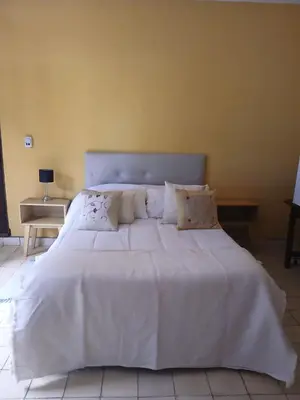 a large white bed with white sheets and pillows at Varuna- en La Casa de Nanda in San Javier