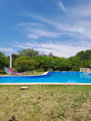 a large blue swimming pool in a park at Varuna- en La Casa de Nanda in San Javier