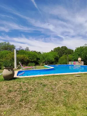 a swimming pool in a field next to a yard at Varuna- en La Casa de Nanda in San Javier