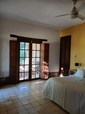 a bedroom with a bed and an open door at Varuna- en La Casa de Nanda in San Javier