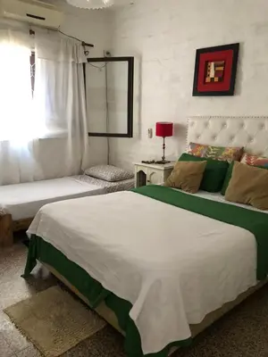 a bedroom with a large bed and a couch at Depto Tribunales in Cordoba