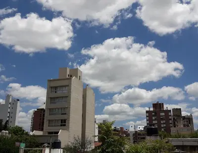 a city skyline with buildings and clouds in the sky at Depto Tribunales in Cordoba
