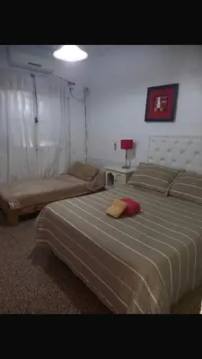 a bedroom with a large bed and a couch at Depto Tribunales in Cordoba