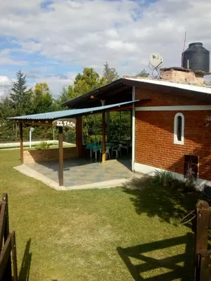 a brick building with a patio with a table at El Faro in Potrero de Garay