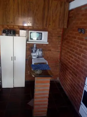 a kitchen with a white refrigerator and a microwave at El Faro in Potrero de Garay