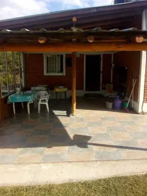 a patio with awning and a table and chairs at El Faro in Potrero de Garay