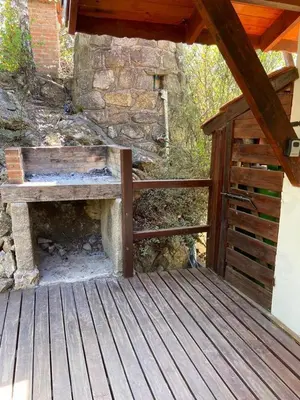 a wooden bench sitting on a wooden deck at VISTA FRANCA in La Cumbrecita