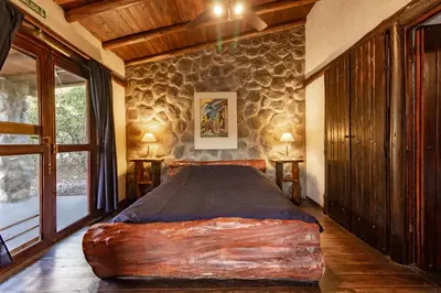 a bedroom with a large log bed in a room at ASM CABAÑAS XIII in Merlo