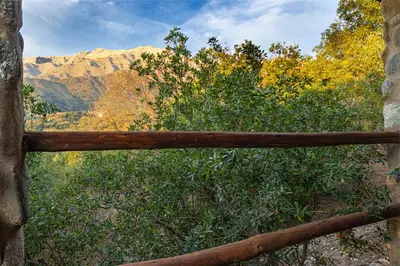 a wooden fence with a view of a mountain at ASM CABAÑAS XIII in Merlo