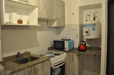 a kitchen with a microwave and a stove top oven at 37 Intendente Doctor Jaime Gil in Río Cuarto