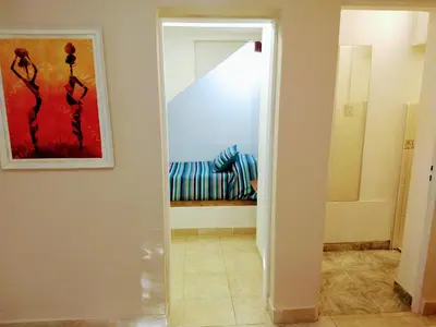 a hallway with a mirror and a couch in a room at CERRO CHICO APART in Cordoba